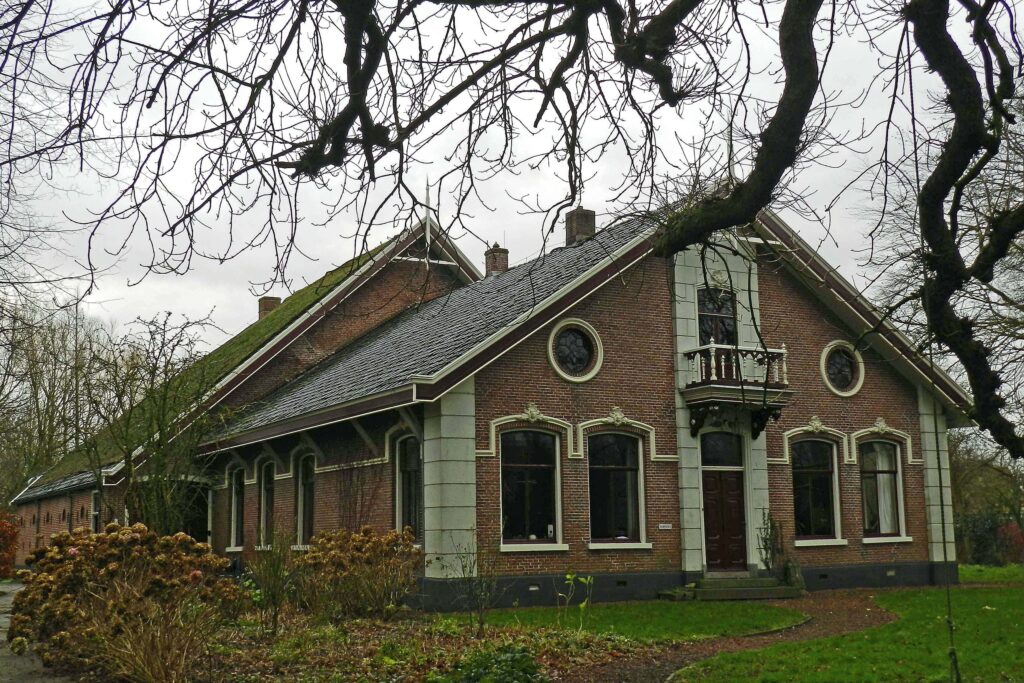 Boerderij van het kop-romp-type gelegen aan de zuidzijde van de dorpsweg